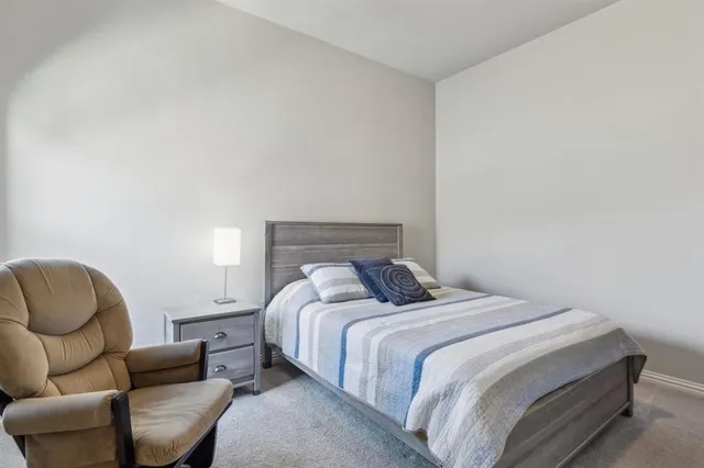 a bedroom with a bed couch and a couch