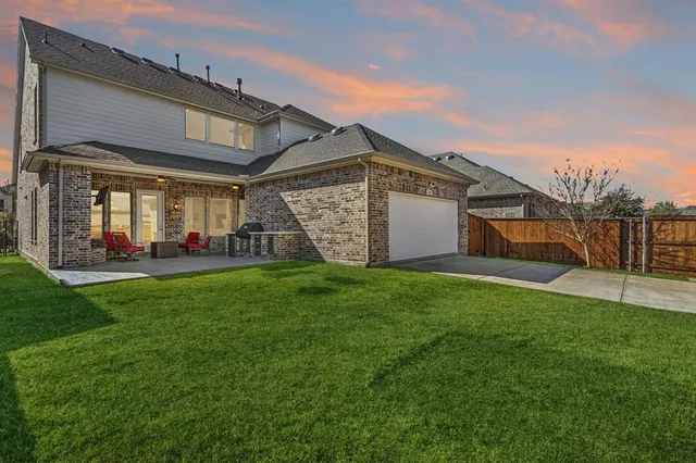 a view of a house with a yard and plants