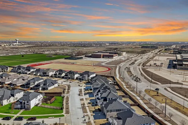 a view of a swimming pool with a yard and outdoor seating