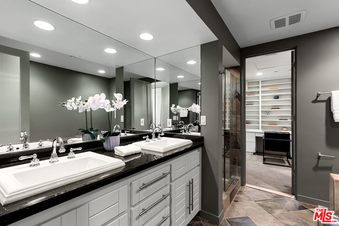 3114 Streamview Lane Studio City, CA 91604 - Photo 11 of 75 a bathroom with double vanity sinks a large mirror and a shower