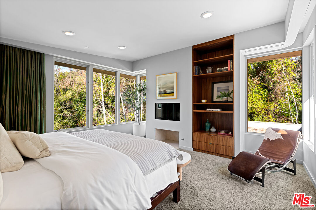 3114 Streamview Lane Studio City, CA 91604 - Photo 28 of 75 a bedroom with a bed and glass window