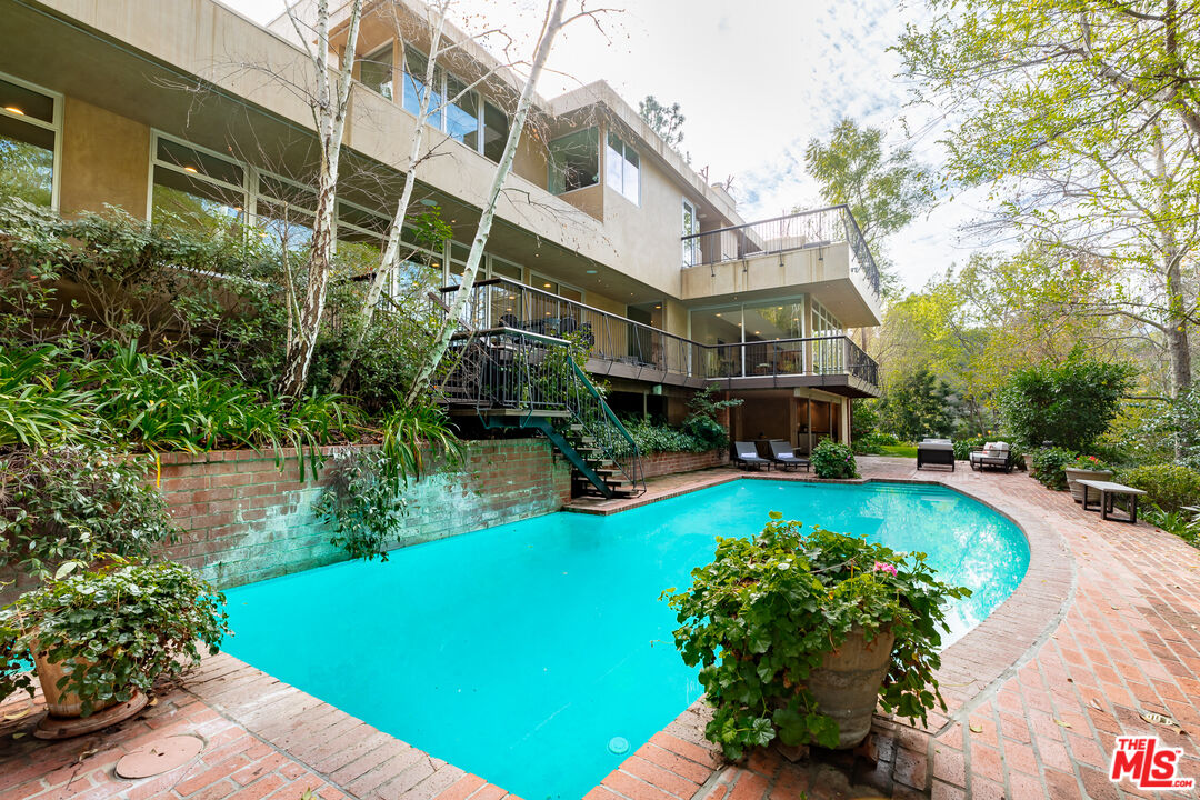 3114 Streamview Lane Studio City, CA 91604 - Photo 45 of 75 a view of a swimming pool with plants and a small yard