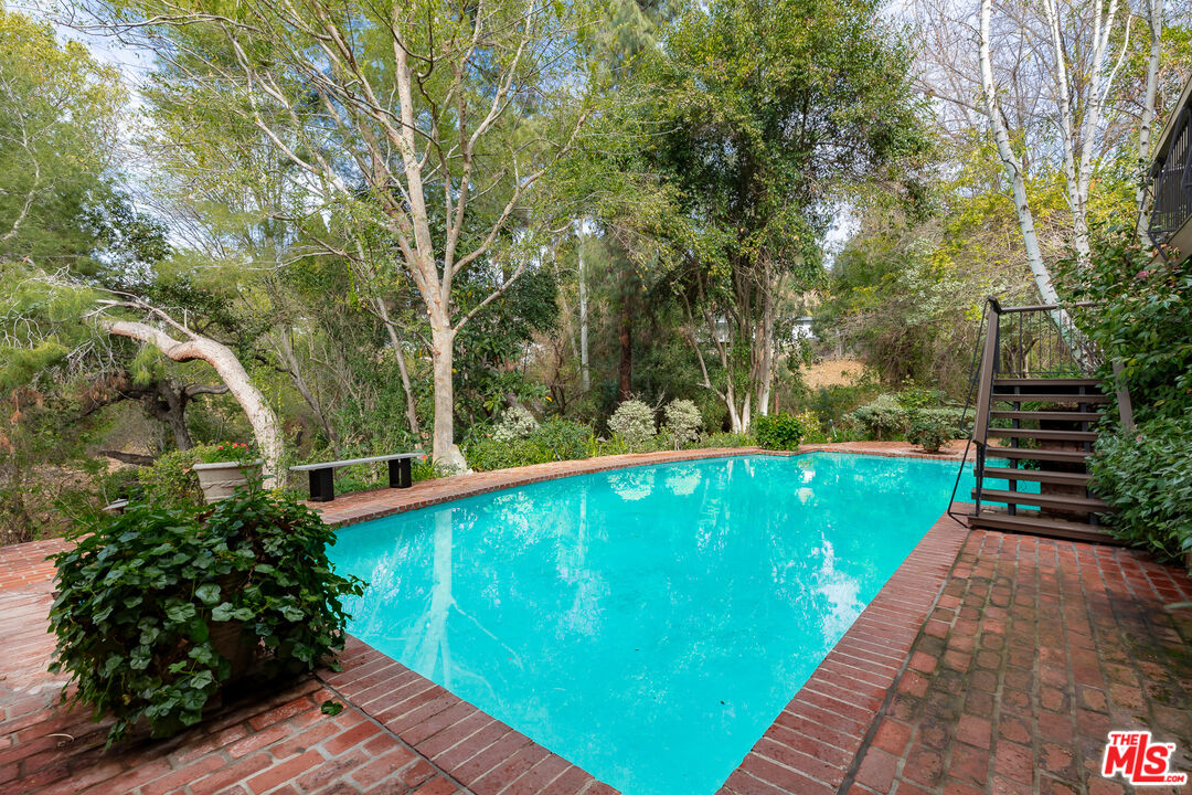 3114 Streamview Lane Studio City, CA 91604 - Photo 53 of 75 a view of a swimming pool with a patio and a yard