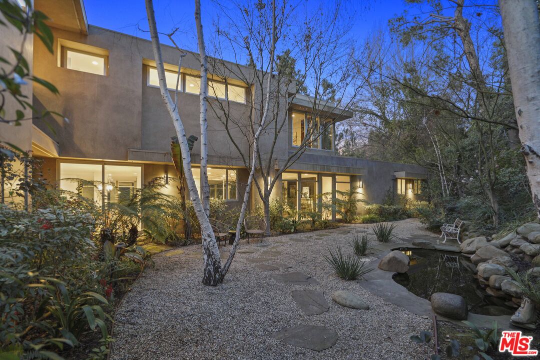 3114 Streamview Lane Studio City, CA 91604 - Photo 63 of 75 a view of a porch with furniture and floor to ceiling windows