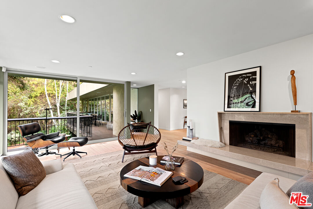 3114 Streamview Lane Studio City, CA 91604 - Photo 8 of 75 a living room with furniture a rug and a fireplace