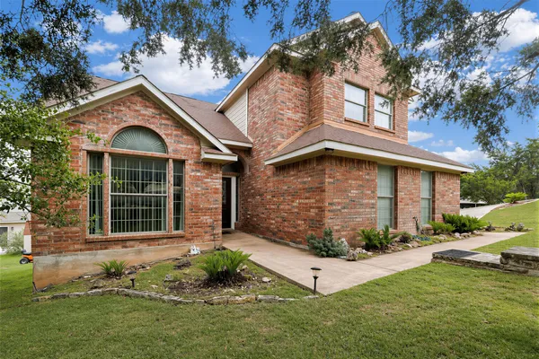 a front view of a house with garden