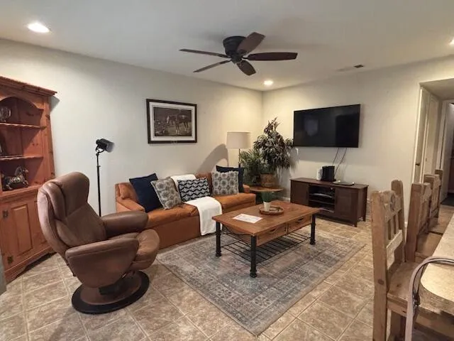 a living room with furniture a rug and a flat screen tv