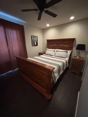 a large bed sitting in a room next to a lamp