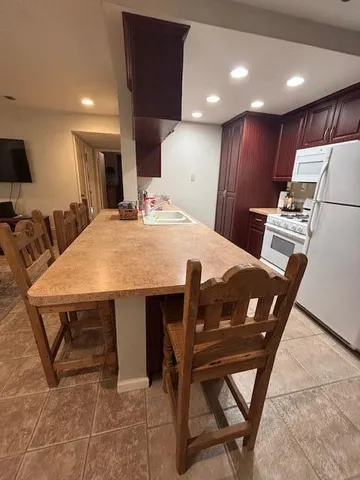 a kitchen with a refrigerator and a sink