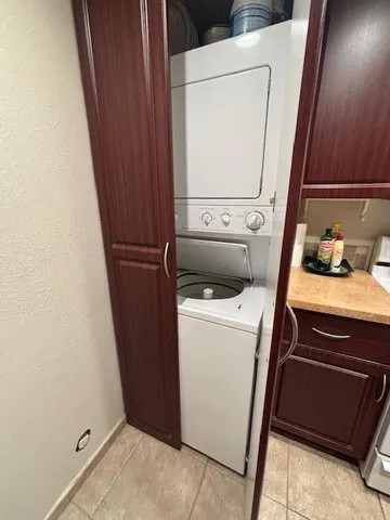 a bedroom with bed and a chandelier