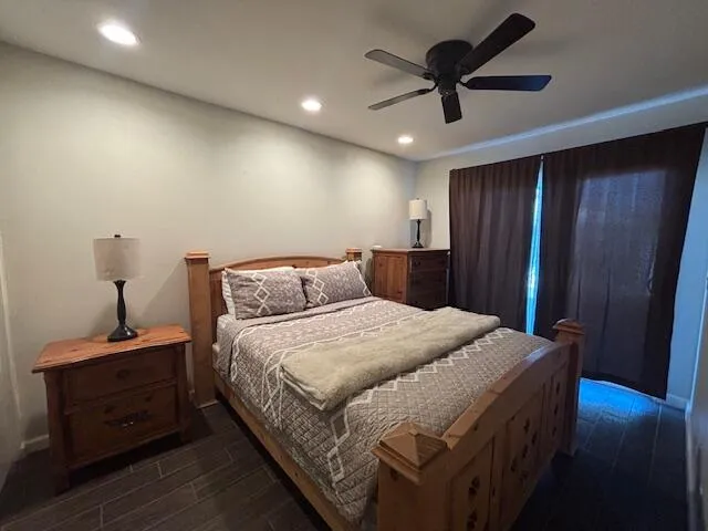 a bedroom with a bed and wooden floor
