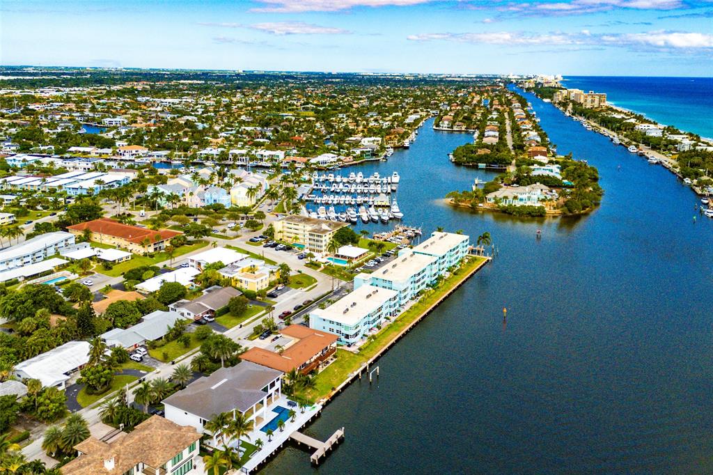 2758 Northeast 30th Avenue, Unit 3A Lighthouse Point, FL 33064 - Photo 24 of 25 an aerial view of water body with boats and trees in the background
