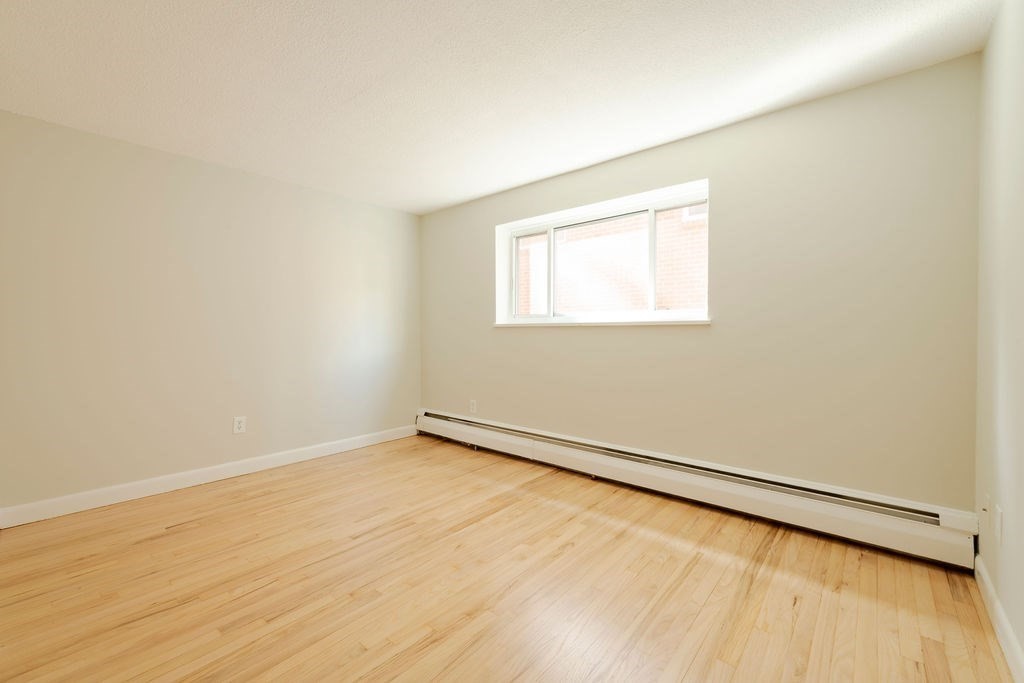 280 Corey Road, Unit 23 Boston, MA 02135 - Photo 11 of 19 an empty room with a workbench