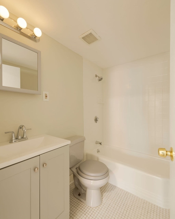 280 Corey Road, Unit 23 Boston, MA 02135 - Photo 14 of 19 a bathroom with a sink a toilet and shower