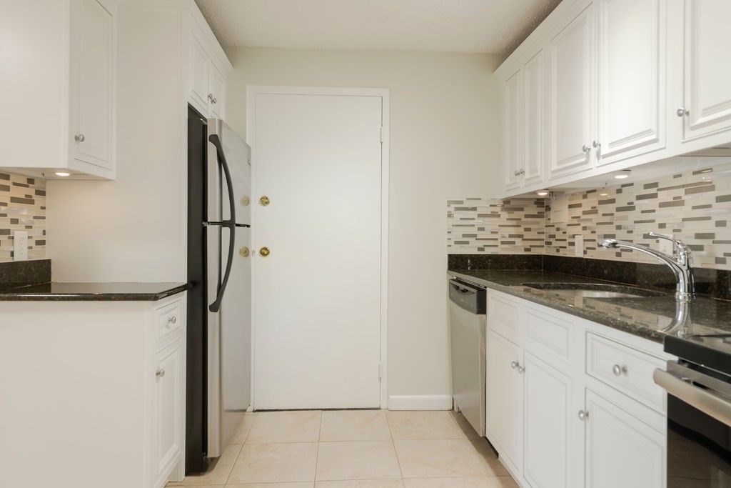 280 Corey Road, Unit 23 Boston, MA 02135 - Photo 7 of 19 a kitchen with white cabinets and refrigerator