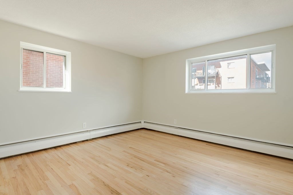 280 Corey Road, Unit 23 Boston, MA 02135 - Photo 9 of 19 a view of an empty room with wooden floor and a window