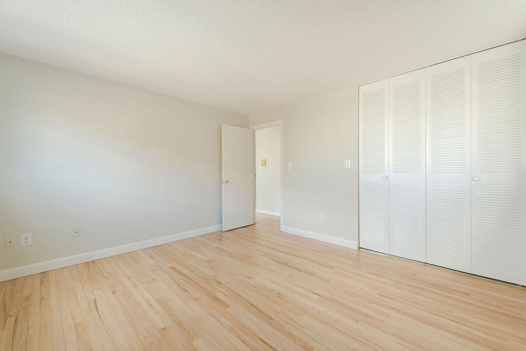 280 Corey Road, Unit 23 Boston, MA 02135 - Photo 10 of 19 a view of an empty room with wooden floor