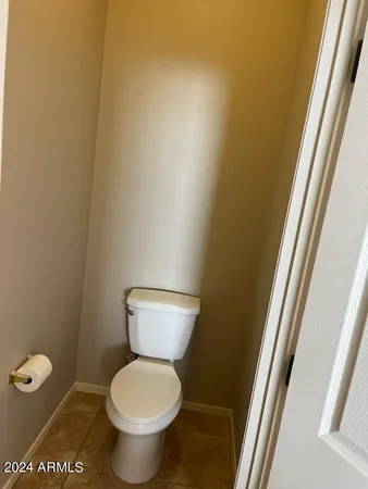 a white toilet sitting next to a sink