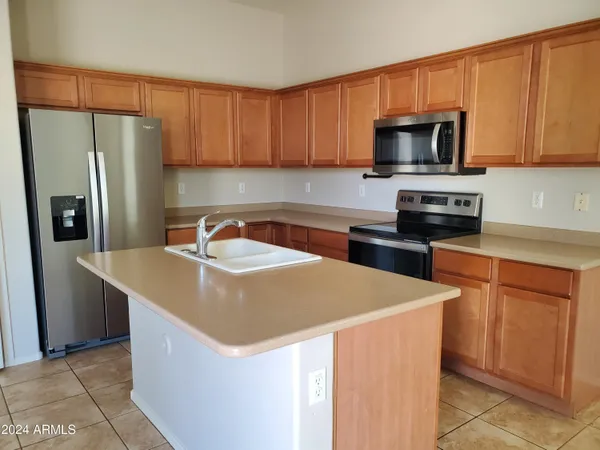 a kitchen with stainless steel appliances a refrigerator stove microwave and sink