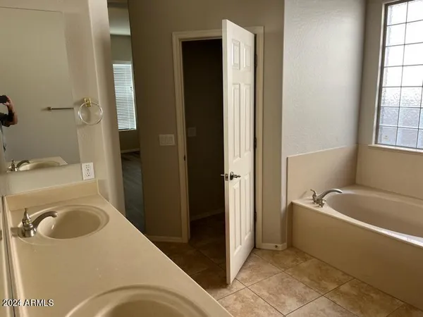 a bathroom with a tub a toilet and a sink