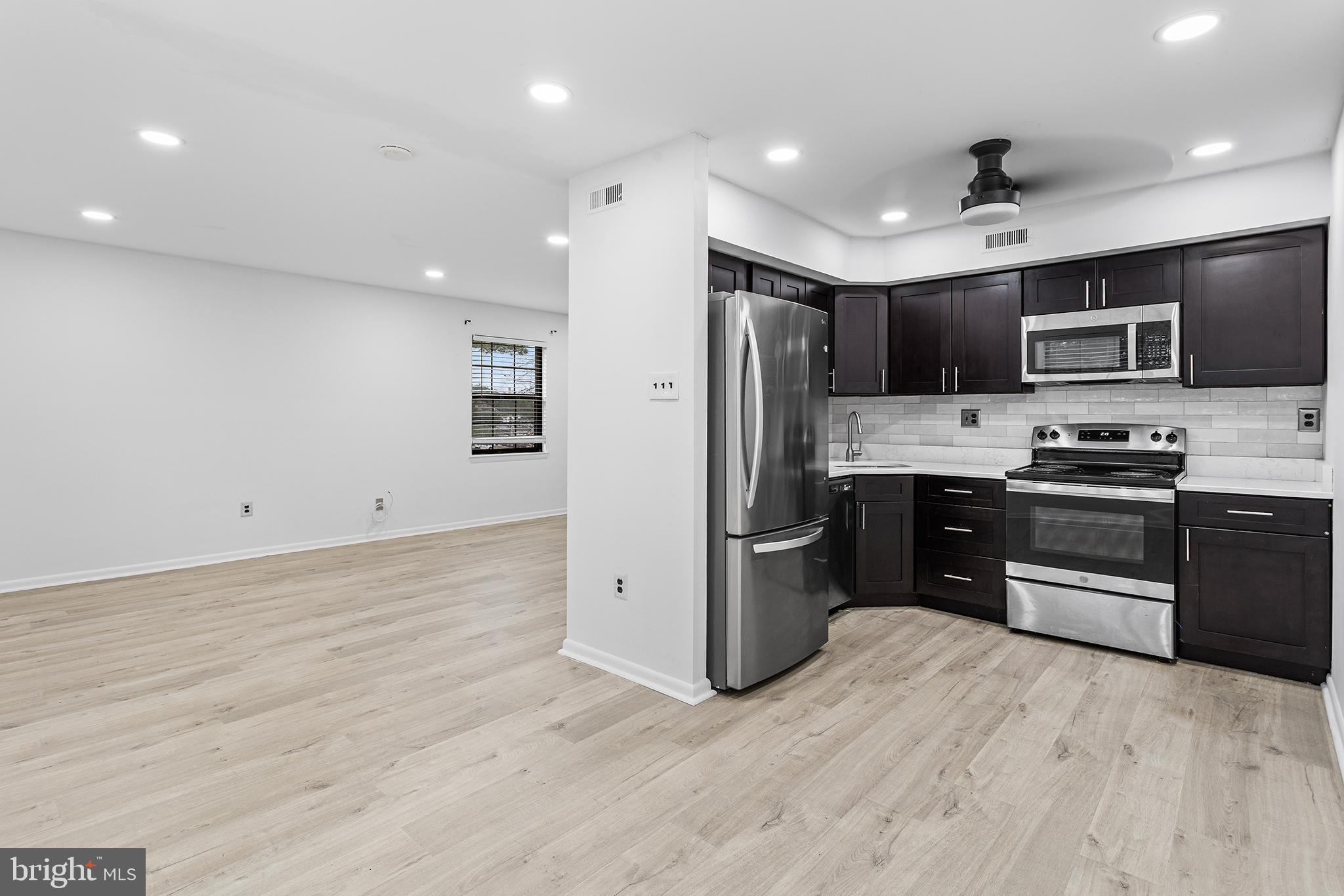 438 B Willow Turn Mount Laurel, NJ 08054 - Photo 11 of 27 a kitchen with stainless steel appliances kitchen island granite countertop a refrigerator stove top oven and sink