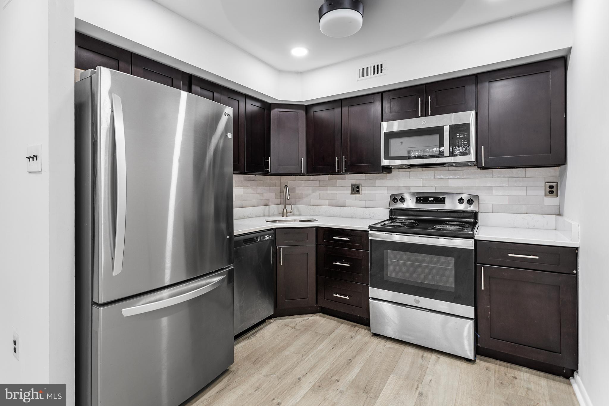 438 B Willow Turn Mount Laurel, NJ 08054 - Photo 13 of 27 a kitchen with stainless steel appliances granite countertop a refrigerator stove a sink dishwasher and microwave