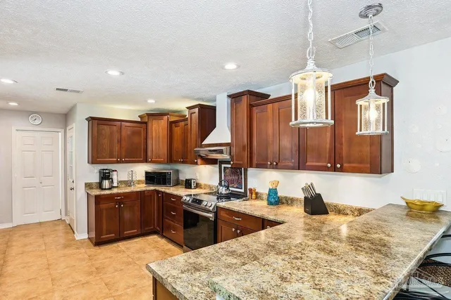 a kitchen with a sink a counter top space appliances and cabinets
