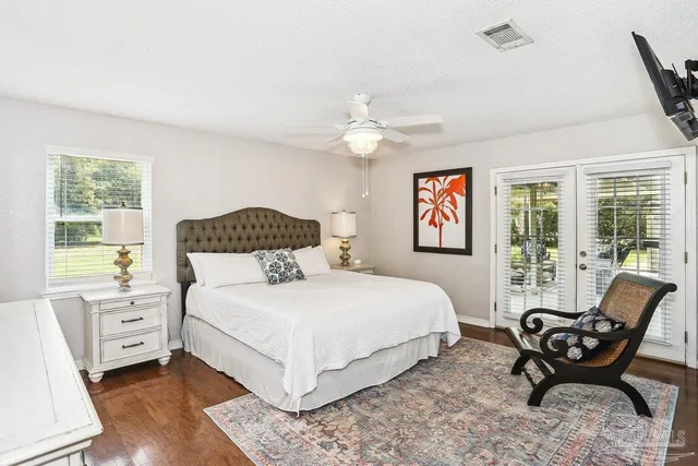a bathroom with a granite countertop sink a toilet and a shower