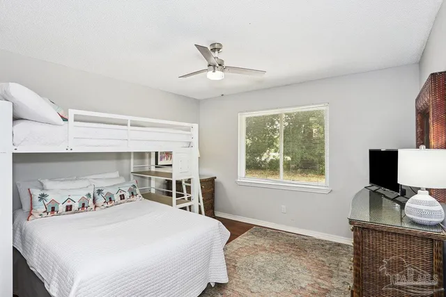 a bathroom with a granite countertop sink mirror vanity and toilet