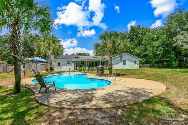 a front view of house with yard and green space