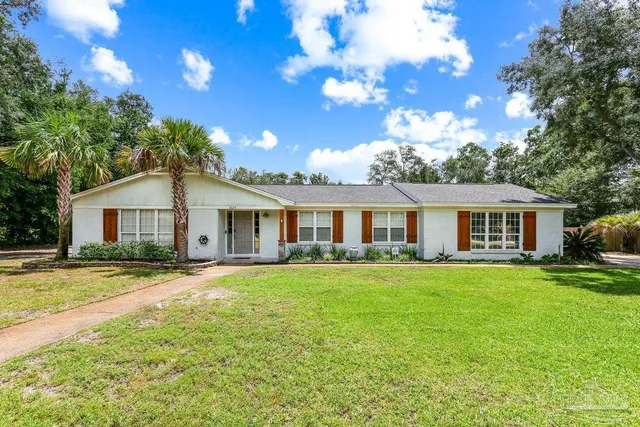 a front view of a house with garden