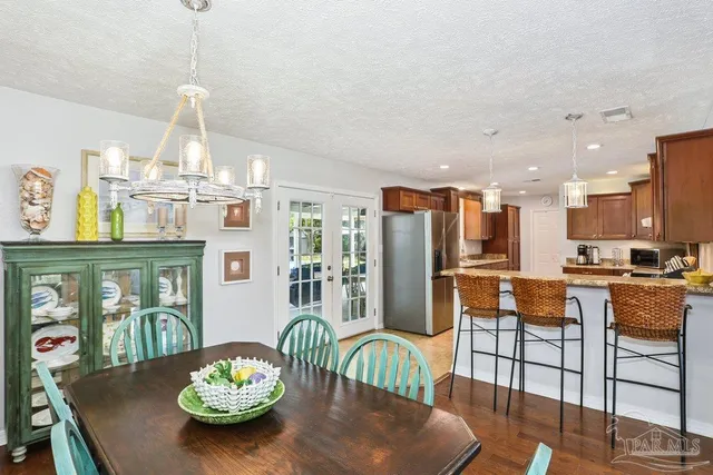 a dining room with furniture and a chandelier