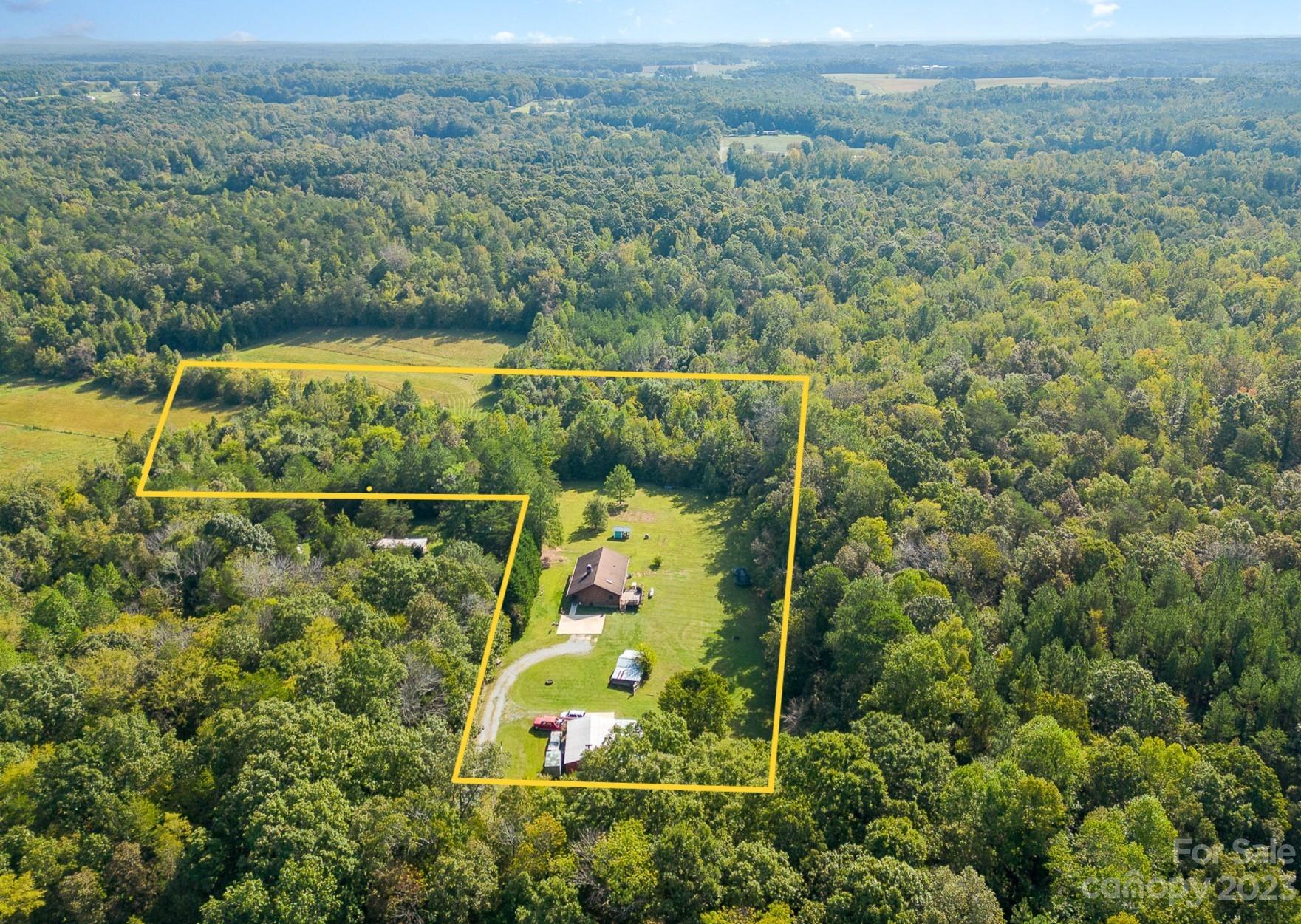 an aerial view of a houses with a yard