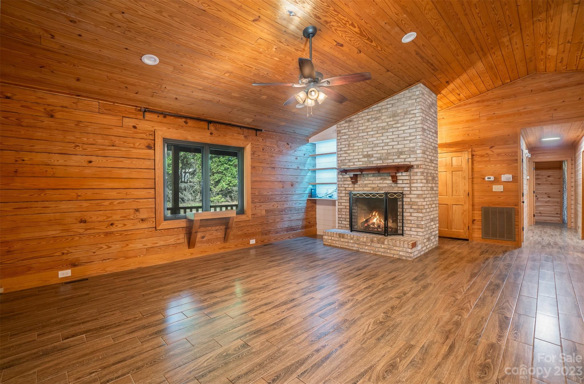 494 Graystone Road Rockwell, NC 28138 - Photo 12 of 36 a view of a livingroom with wooden floor a fireplace and window
