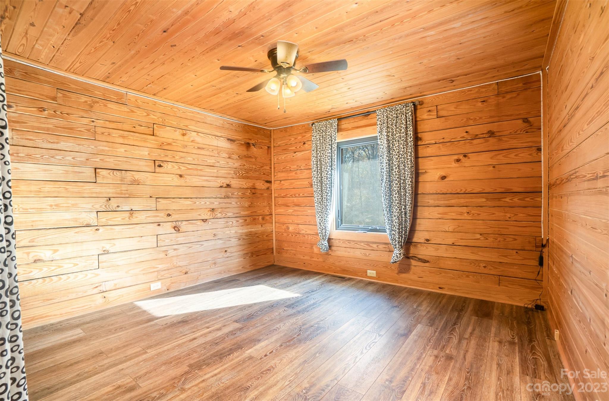 494 Graystone Road Rockwell, NC 28138 - Photo 23 of 36 a view of empty room with wooden floor and fan