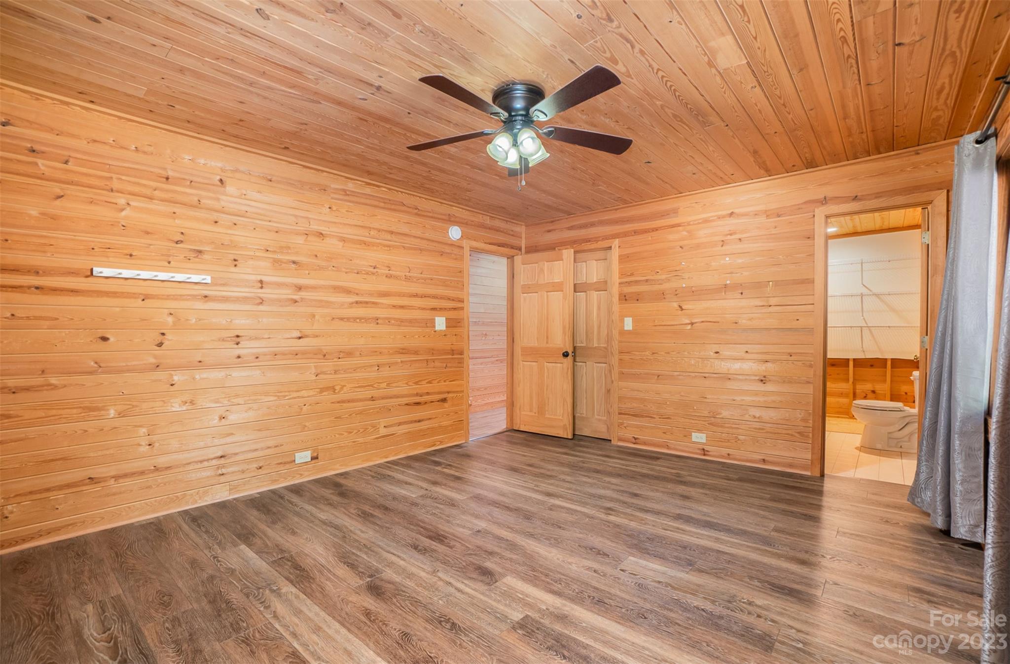 494 Graystone Road Rockwell, NC 28138 - Photo 26 of 36 a view of a livingroom with wooden floor and a ceiling fan