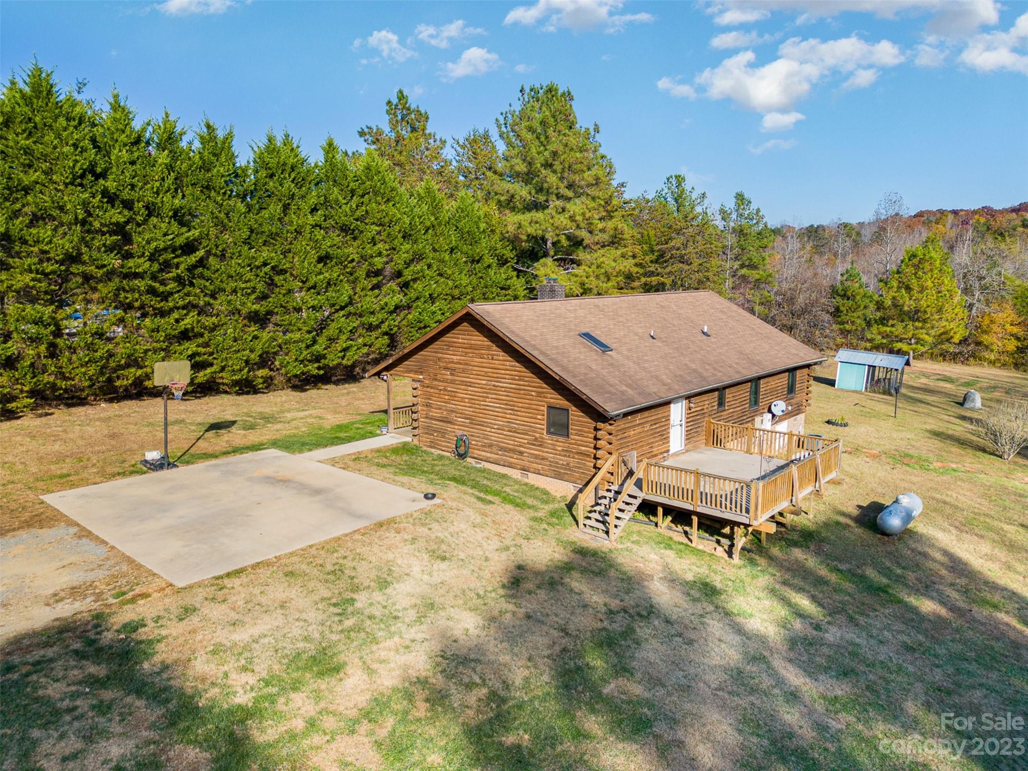 494 Graystone Road Rockwell, NC 28138 - Photo 32 of 36 a roof deck with table and chairs under an umbrella