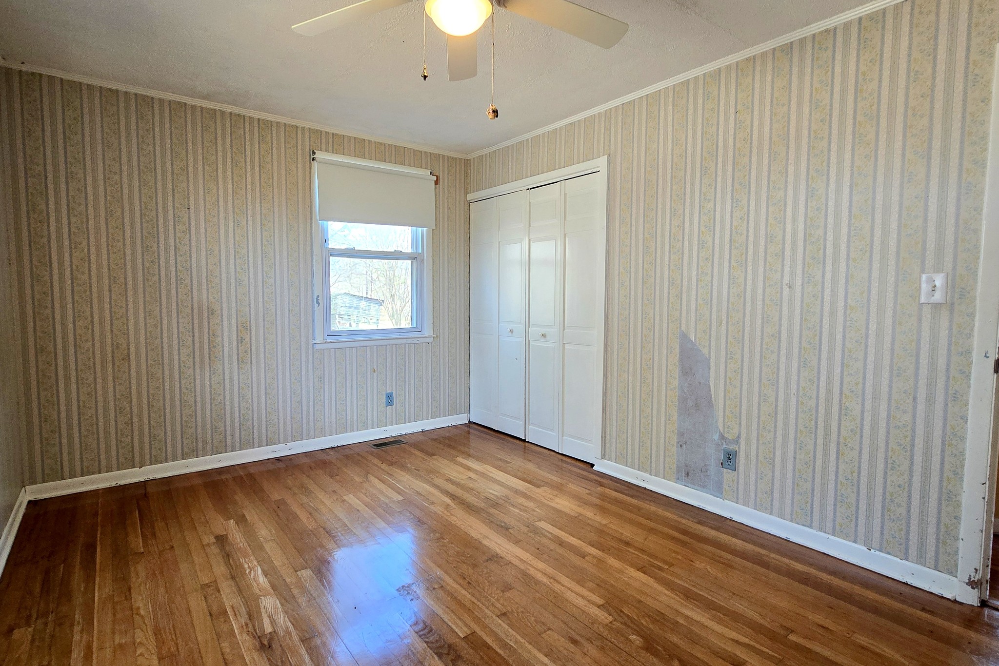 3467 Shouse Road Santa Fe, TN 38482 - Photo 28 of 55 an empty room with wooden floor chandelier fan and windows