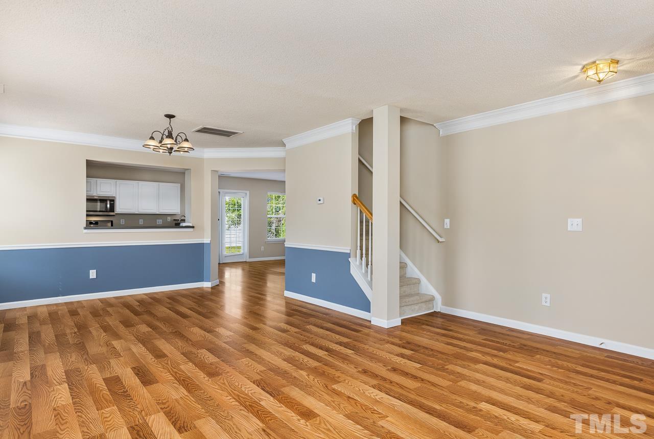 4808 Marathon Lane Raleigh, NC 27616 - Photo 5 of 31 a view of a room with wooden floor and a ceiling fan