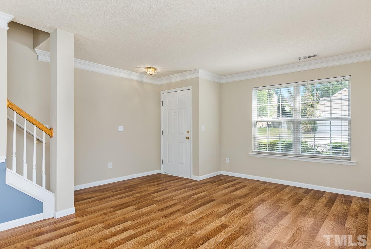 4808 Marathon Lane Raleigh, NC 27616 - Photo 6 of 31 a view of an empty room with wooden floor and a window