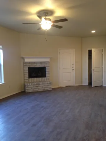 a view of an empty room with a fireplace