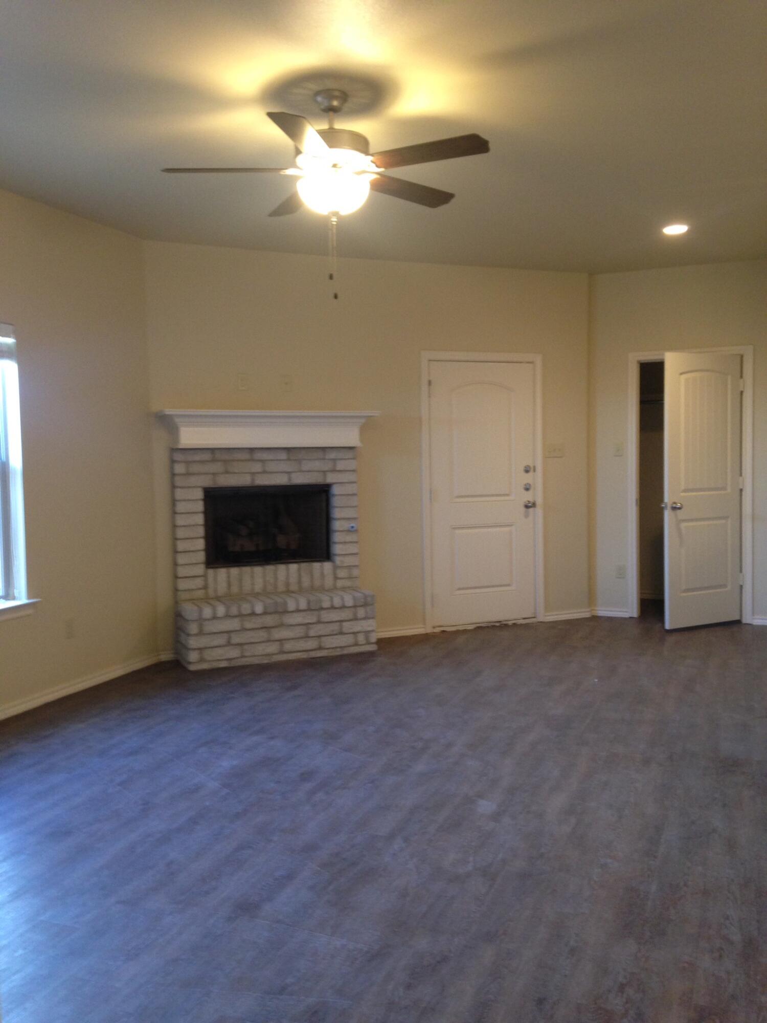 1212 Preston Trail, Unit A Wolfforth, TX 79382 - Photo 2 of 12 a view of an empty room with a fireplace