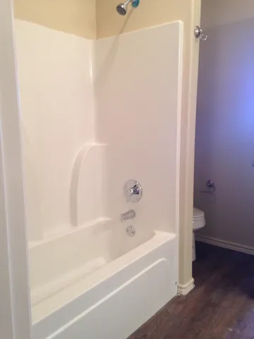 a bathroom with bathtub and shower