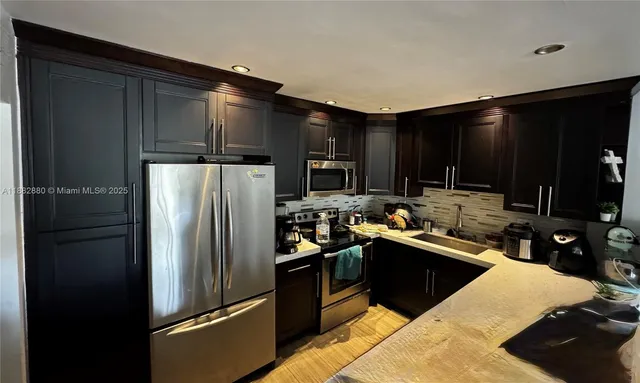 a kitchen with a refrigerator and a sink