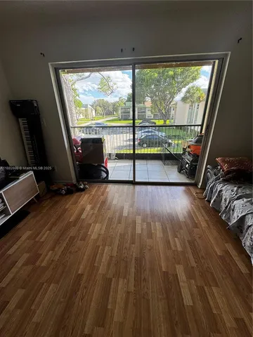 a view of a room with wooden floor and balcony