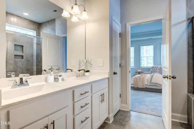 a en suite bathroom with a double sink and mirror