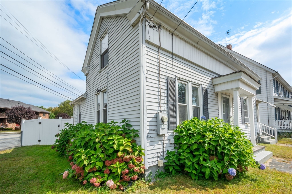 a view of a house with a flower garden
