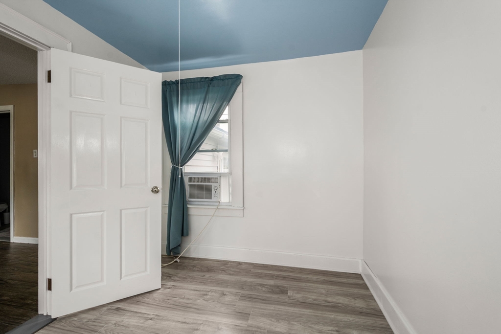 97 Mechanic Street Westfield, MA 01085 - Photo 27 of 40 a view of a hallway with wooden floor and a chandelier
