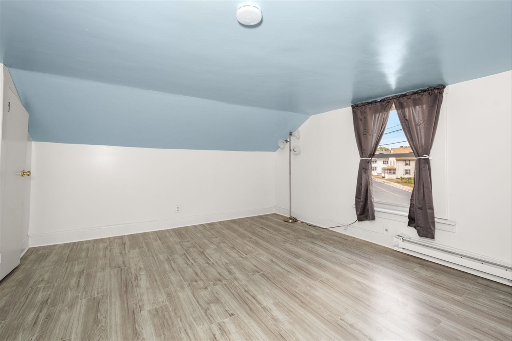 97 Mechanic Street Westfield, MA 01085 - Photo 31 of 40 an empty room with wooden floor and windows