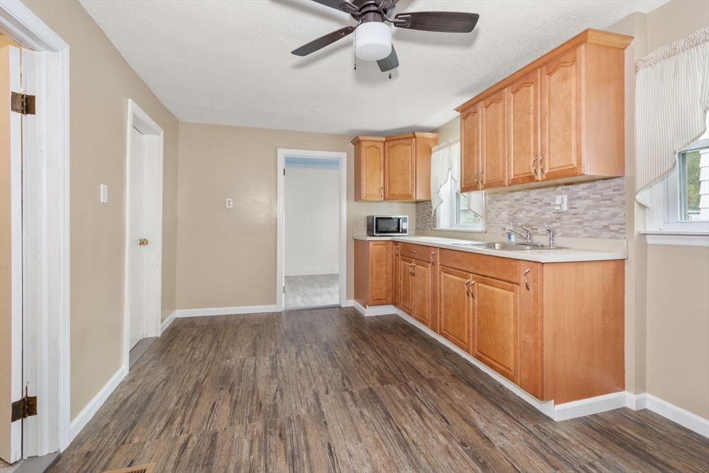 97 Mechanic Street Westfield, MA 01085 - Photo 9 of 40 a kitchen with a sink window and cabinets